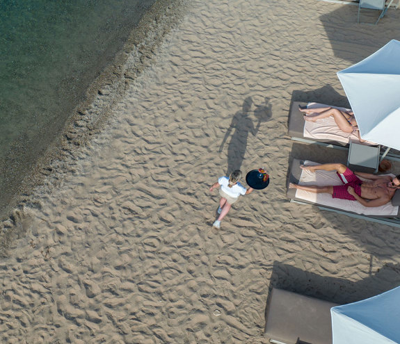 Miraggio customers getting served at the beach by the waiter