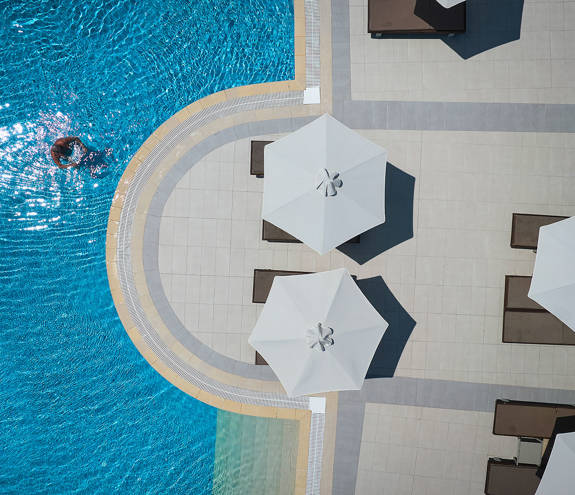 Top-down view of the pool and sunbeds